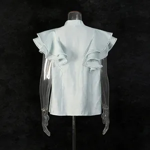 Back view of light blue flutter sleeve top with delicate lace trim on ruffled sleeves
