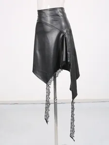 Elegant asymmetric black faux leather skirt featuring a delicate lace patchwork hem design