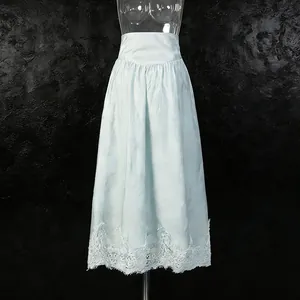 Detail view of light blue high-waist A-line skirt with delicate white lace hemline
