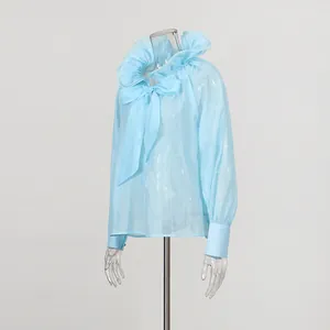 Elegant light blue French sheer blouse with ruffled collar and large decorative bow tie.