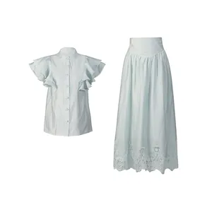 Detail view of pale blue skirt set with ruffled flutter sleeves and lace hem skirt