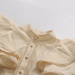 Close-up detail of vintage flutter sleeve blouse with lace trim and buttons