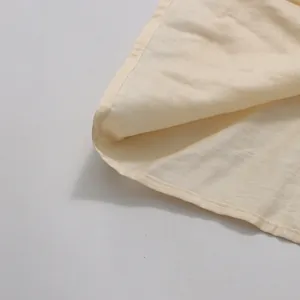 Detailed view of the neat stitching and linen-like fabric texture of the cream skirt