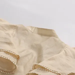 Detail of vintage beige top with ruffled small flying sleeves and delicate lace trim