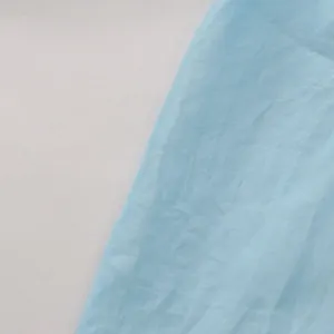 Close-up of light blue mesh fabric showing delicate crinkled texture for women's shirt