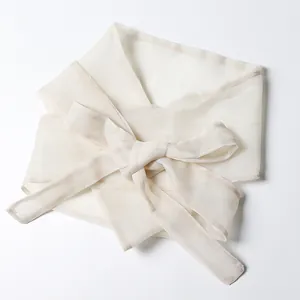 Detailed view of elegant cream-white chiffon waist tie tied in a large bow knot