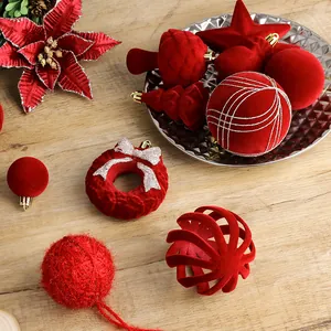 Set di eleganti ornamenti natalizi floccati rossi con palline, stelle e fiori festivi.