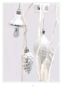 Close-up of white and silver Christmas ornaments with mushroom and pinecone shapes