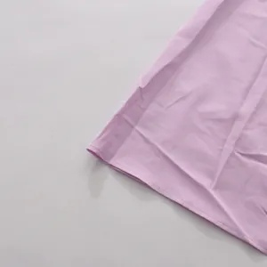 Detail of lavender French style dress hem with high-quality stitching and light fabric
