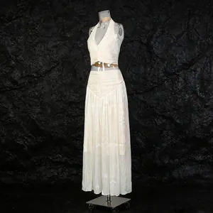 Detailed side view of cream French style pleated maxi skirt and halter top set