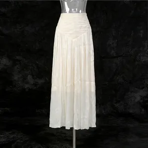 Elegant French style cream pleated maxi skirt with shimmering fabric on mannequin