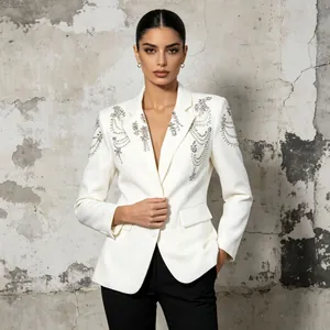Elegant white blazer featuring intricate beaded shoulder details and lapel rhinestones