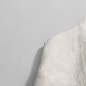 Close-up detail of white pleated fabric texture for French style sleeveless top