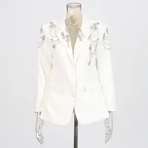 Exquisite detail of white blazer featuring heavy beadwork and rhinestone designs