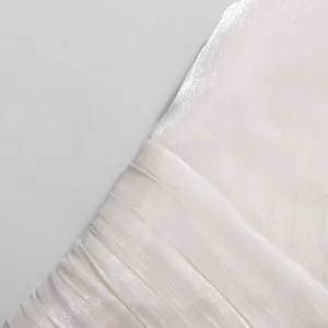 Macro detail of the elegant white pleated fabric texture for a French style women's two-piece set