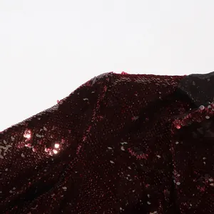 Macro view of burgundy sequins on a stylish V-neck blazer for women