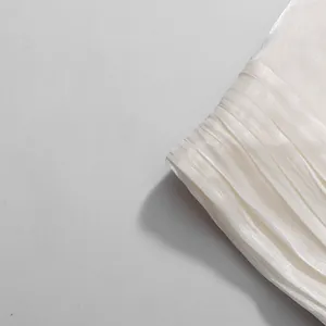 Close-up detail of premium pleated fabric from white French style elegant set