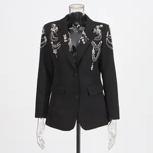Detail view of a black women's blazer with intricate silver beadwork and rhinestones