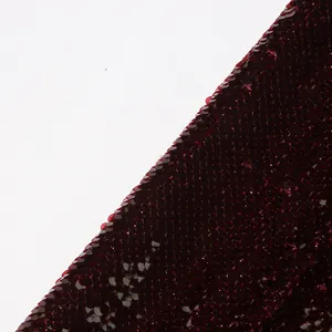 Detailed macro shot of burgundy sequin fabric texture for women's stylish suit jacket