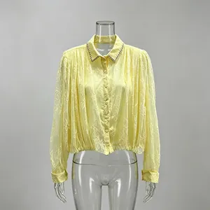 Detail of French style yellow lace mesh blouse with beaded collar
