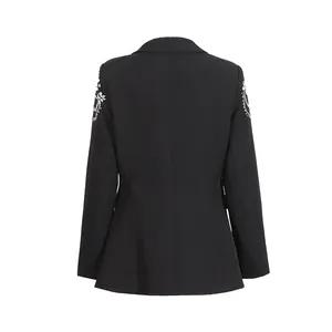 Rear view of a black blazer featuring ornate rhinestone and bead embellishments on the shoulders