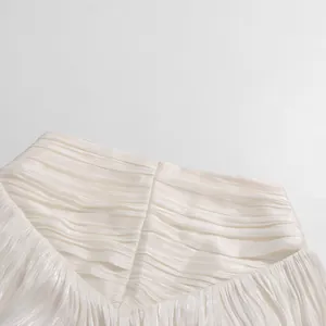 Detailed close-up view of the white plissé pleated fabric with a subtle silky luster finish.