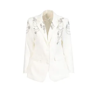Close-up of white women blazer with intricate silver beadwork and rhinestone chain details