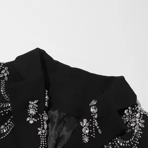 Detailed macro shot of heavy rhinestone and beadwork on a black fashion blazer collar