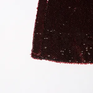Close-up detail of dark red sequined fabric on a stylish women's blazer