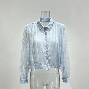 Elegant French-style light blue lace blouse with long sleeves and beaded collar detail