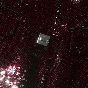 Close-up detail showing shimmering burgundy sequin fabric and square metal button