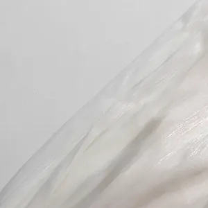 Detail shot of white shimmery pleated fabric with elegant pearlescent texture