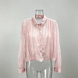 Pink French style lace shirt with rhinestone collar detail on a mannequin.