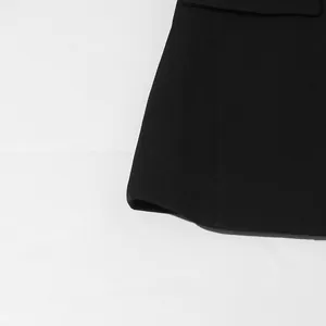 Detailed close-up view of a black women's fashion blazer showing the hem and fabric texture