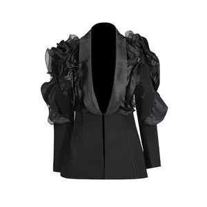 Detail eines schwarzen Blazers mit tiefem V-Ausschnitt und 3D-Rüschenschultern