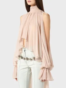 Close-up detail of elegant ruffled cuffs and draped high neck of a pink chiffon blouse