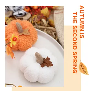 Close-up of soft plush pumpkins in orange and white for fall harvest home decoration