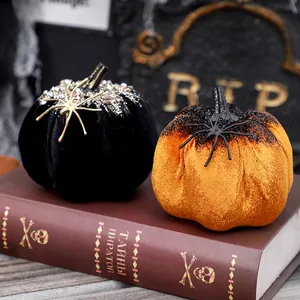 Handcrafted Halloween velvet pumpkins with spider decorations for festive tabletop display