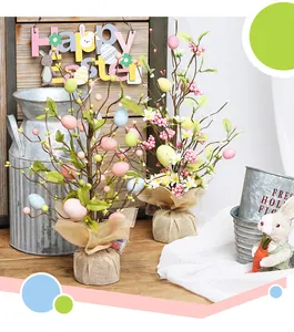 Detailed view of LED lighted Easter egg trees with burlap base on wooden desk