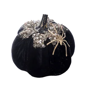 Elegant black velvet Halloween pumpkin decor with gold spider and silver glitter