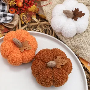 Soft plush pumpkin ornaments in autumn colors for Halloween and Thanksgiving home decor