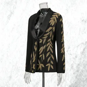 Detailed view of luxury black blazer featuring intricate gold leaf embroidery design