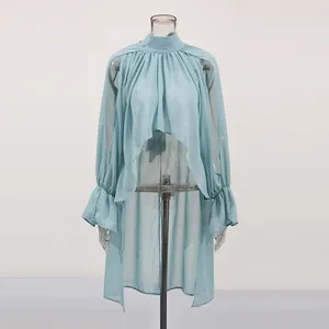 Front view of light blue sheer asymmetrical blouse with stand collar on mannequin.