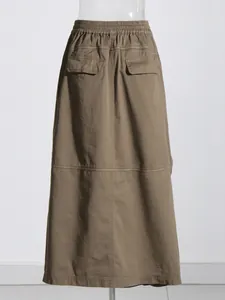 Back view of brown high-waist midi skirt with pockets and white contrast stitching detail