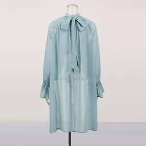 Back detail of a light blue sheer chiffon French blouse featuring a large elegant bow tie