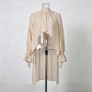Elegant French style beige mock neck shirt with irregular high-low hem and ruffled cuffs.