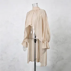 Detailed side view of a beige chiffon blouse featuring ruffled sleeves and irregular hem