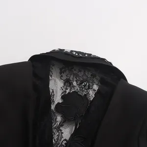 Macro detail view of black lace hollow embroidery with rose applique on suit jacket