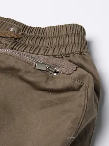 Detailed macro shot of khaki high-waisted skirt featuring elastic waist and zipper pocket