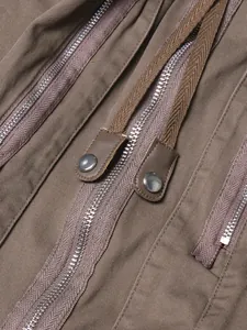 Detail of heavy-duty zippers and brown cotton fabric on a high-waisted midi skirt
